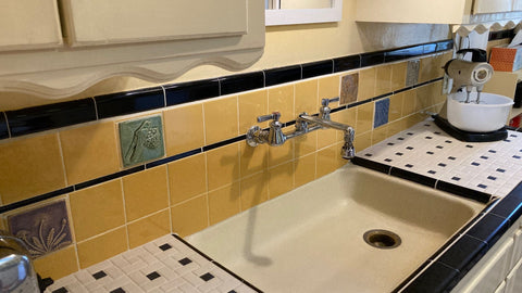 a 1939 vintage tile kitchen which has been slightly modified to include handmade arts and crafts style tiles