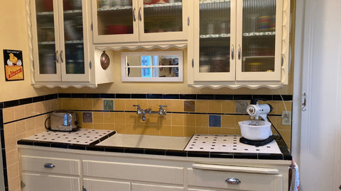 a 1939 vintage tile kitchen which has been slightly modified to include handmade arts and crafts style tiles