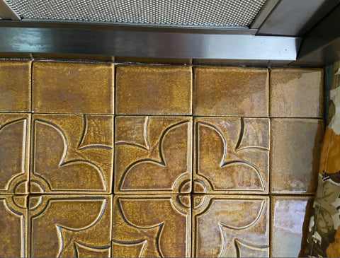 close up of quatrefoil handmade tiles installed in a backsplash