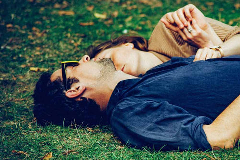 Couple sleeping on the grass