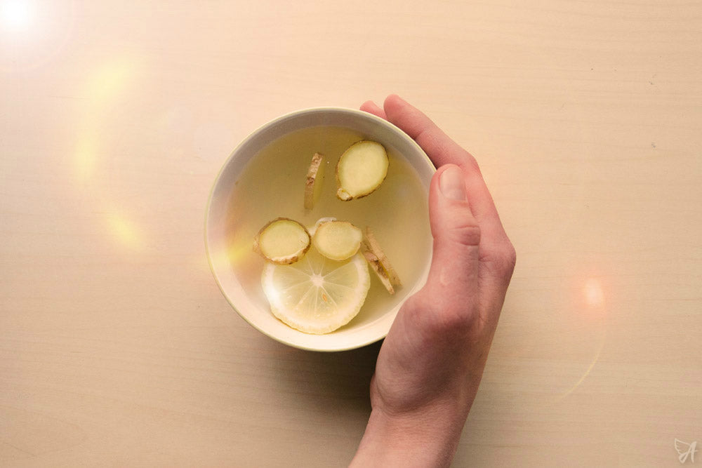 Hand holding ginger drink