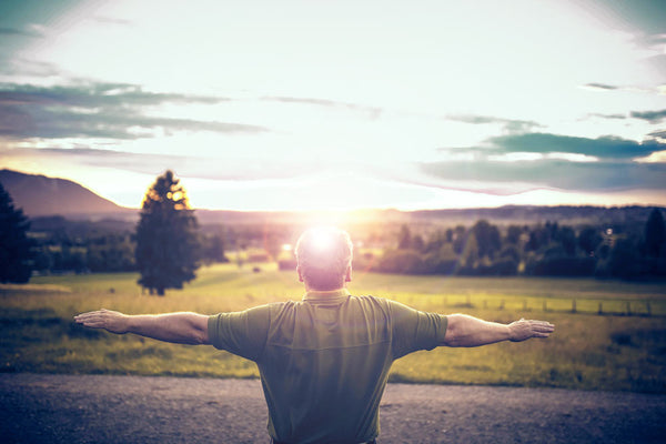 Invigorated stretching man - sunrise