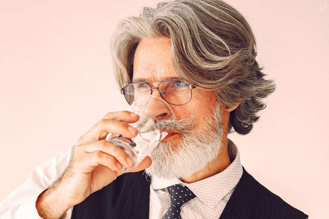 Mature man drinking water