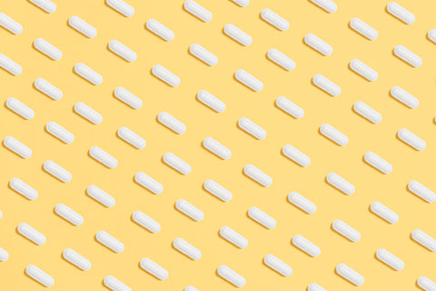 Pills on yellow background