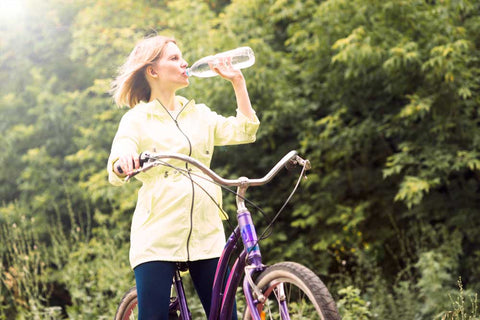 Woman drinking water bicycle