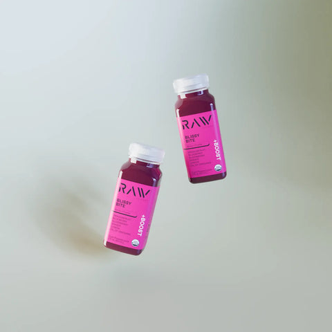 Juice diet plan with two RAW Blissy Bite bottles floating on a soft gradient background