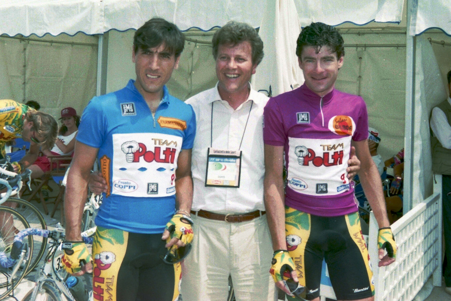 It was all smiles before stage 11 (Marostica - Bibione) of the 1994 Giro D'Italia.  If you have to ride all day, every day in the Polti jersey, it's little wonder why Gianni Bugno and Djamolidine Abduzhaparov look so happy to swap their standard team jersey for the maglia azzurro e maglia ciclamino!  Photo: Fotoreporter Sirotti.