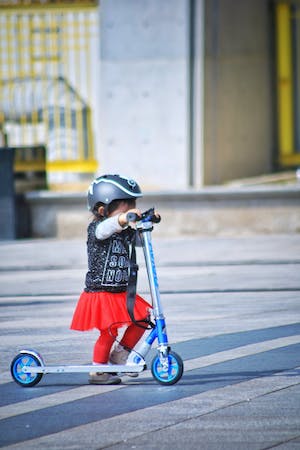 child riding scooter