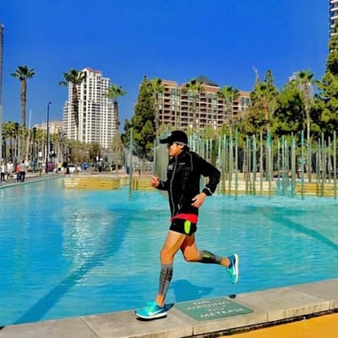 Man running in Zensah Featherweight Compression Leg Sleeves