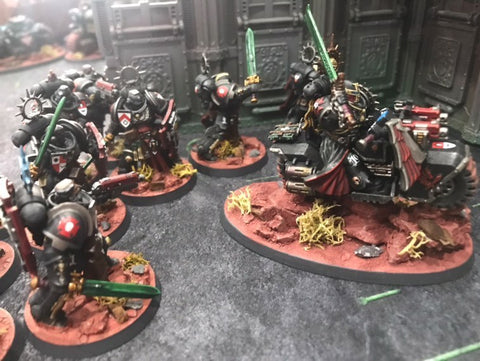 Black Templars marines gathering for a charge behind a bike-mounted hero