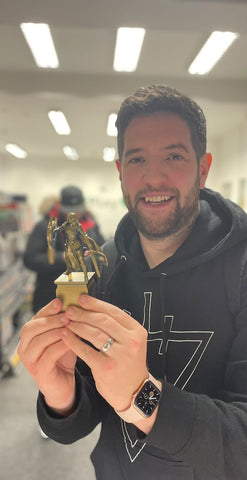 Jim Tinsdale holding a gold trophy