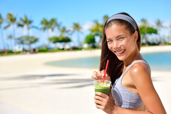 woman drinking a healthy shake after exercise