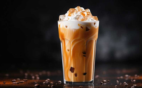Closeup of Iced Caramel Macchiato with coffee beans on a dark background.