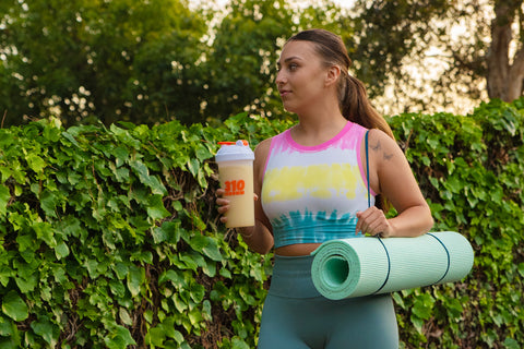 Girl heading to a yoga class with a healthy meal replacement shake.