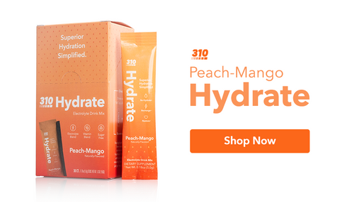 310 Hydrate electrolyte drink mix in vibrant orange packaging with "Shop Now" button.