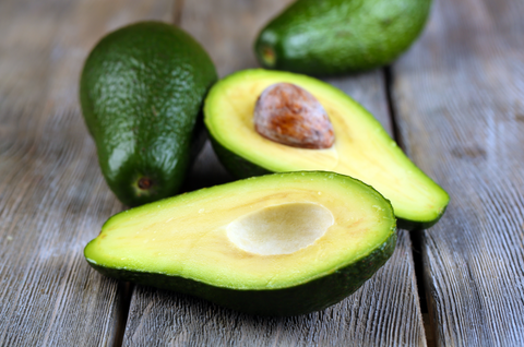 Sliced avocados on wooden counter