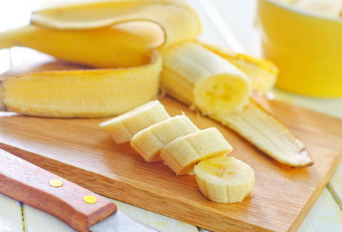 sliced bananas on wooden chopping board