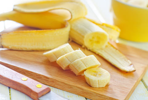 sliced bananas on wooden cutting board