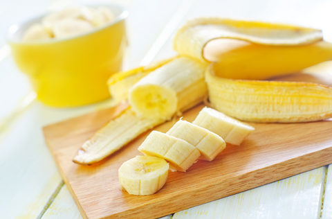 sliced bananas on wooden cutting board