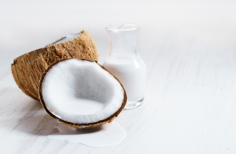 Coconut with half and coconut milk on white background