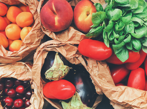 assorted fruits and veggies in paper bags