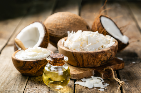 mct oil and coconuts on wooden table