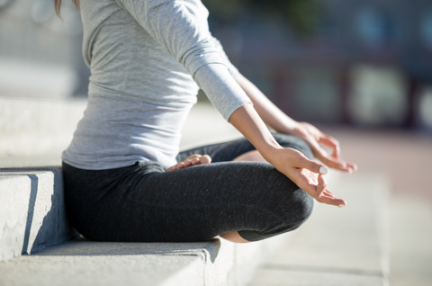 Woman meditating on a step