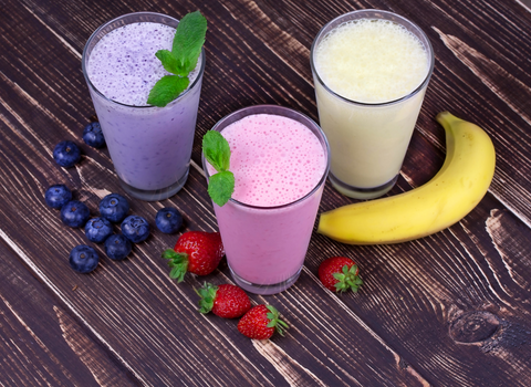 fruit smoothies on wooden table