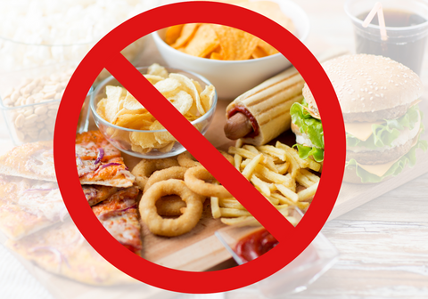fast food snacks and cola drink on wooden table behind no symbol 