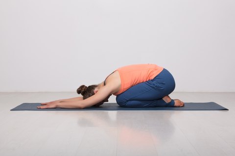 child's pose on yoga mat