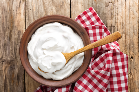 yogurt in bowl wooden background