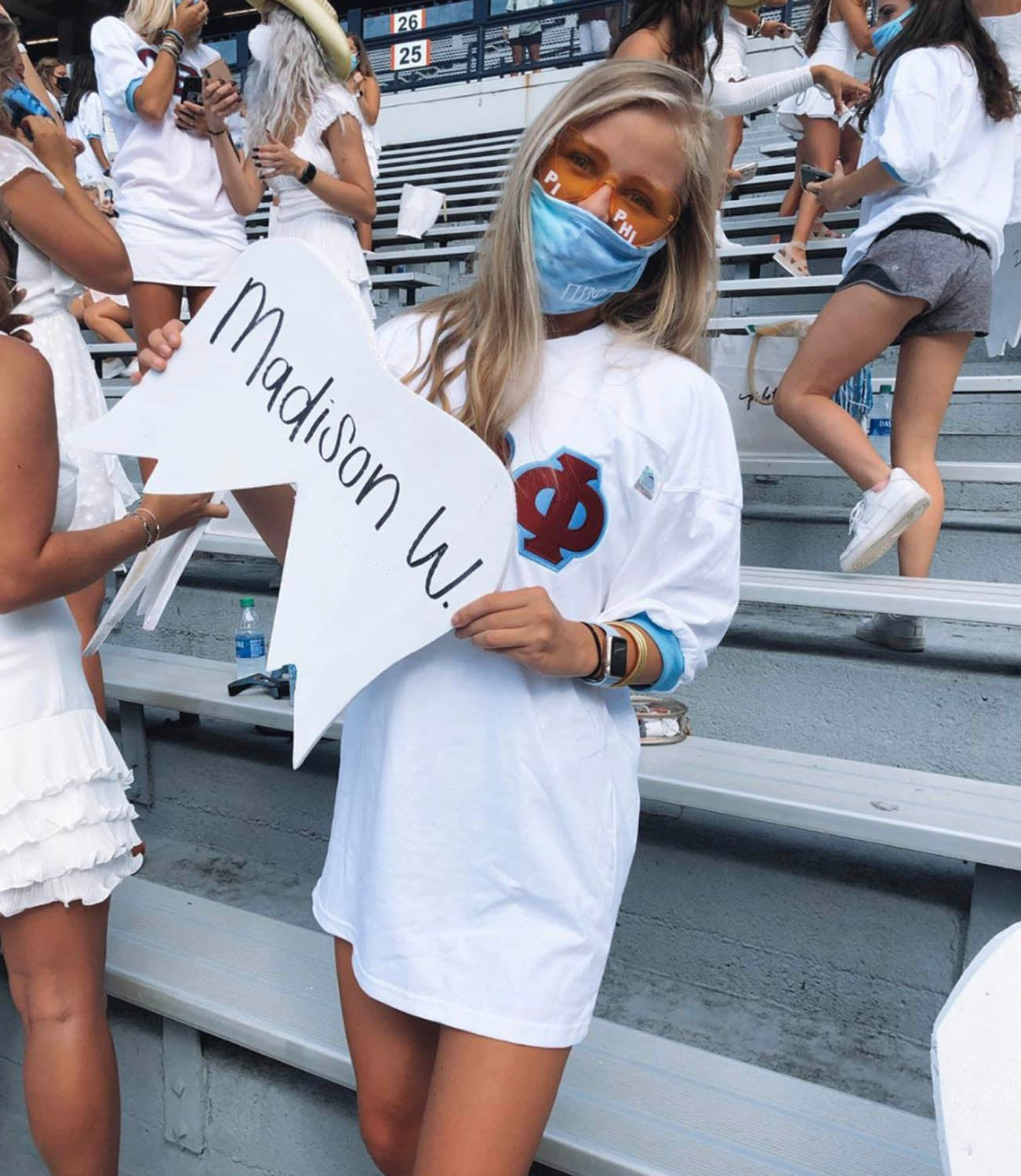 Girl at Auburn University game holding a sign
