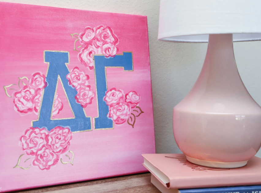 Pink canvas with blue Greek letters