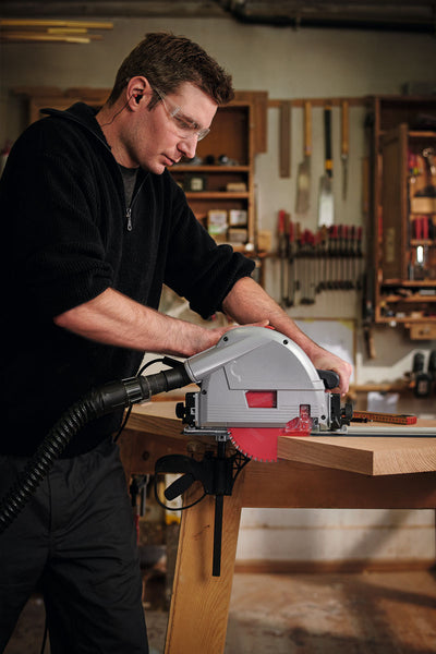 Guy standing in workshop cutting a piece of hardwood using a plunge saw with Freud blade