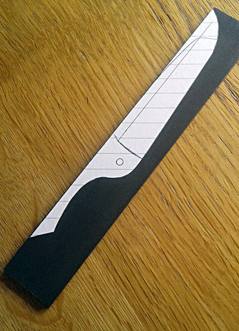 Knife making paper template on substrate