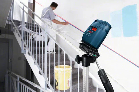 Laser Level being used on a diagonal surface on staircase with user following the guide