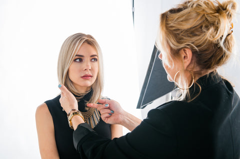 Woman trying on wig in consultation