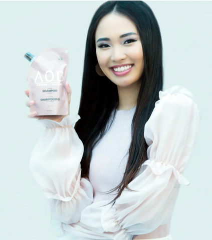 Woman smiling holding AOB Shampoo