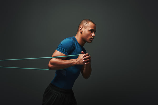 Man In A Blue Shirt With Resistance Bands