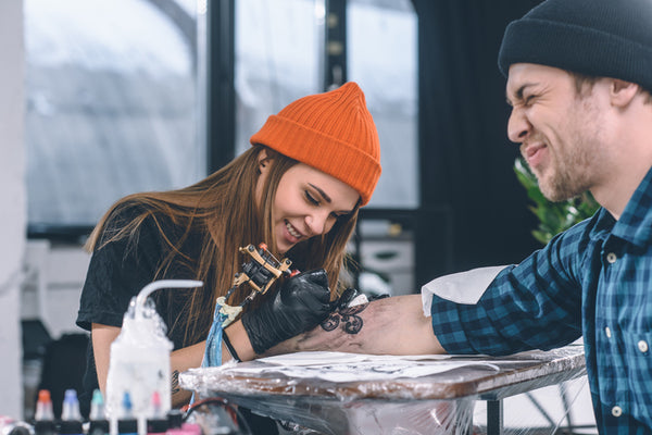 man getting tattoo