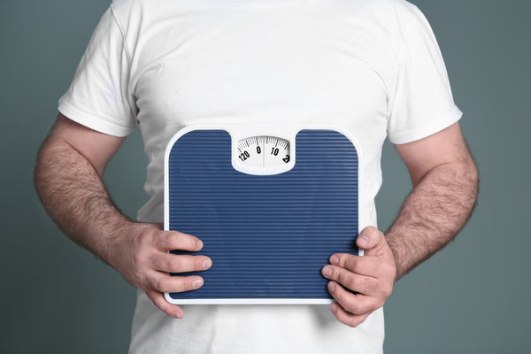 Man Holding A Scale