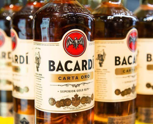 five bottles of Bacardi Carta Oro Superior Gold Rum selected focus