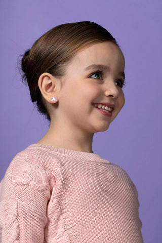 young girl wearing unicorn earrings