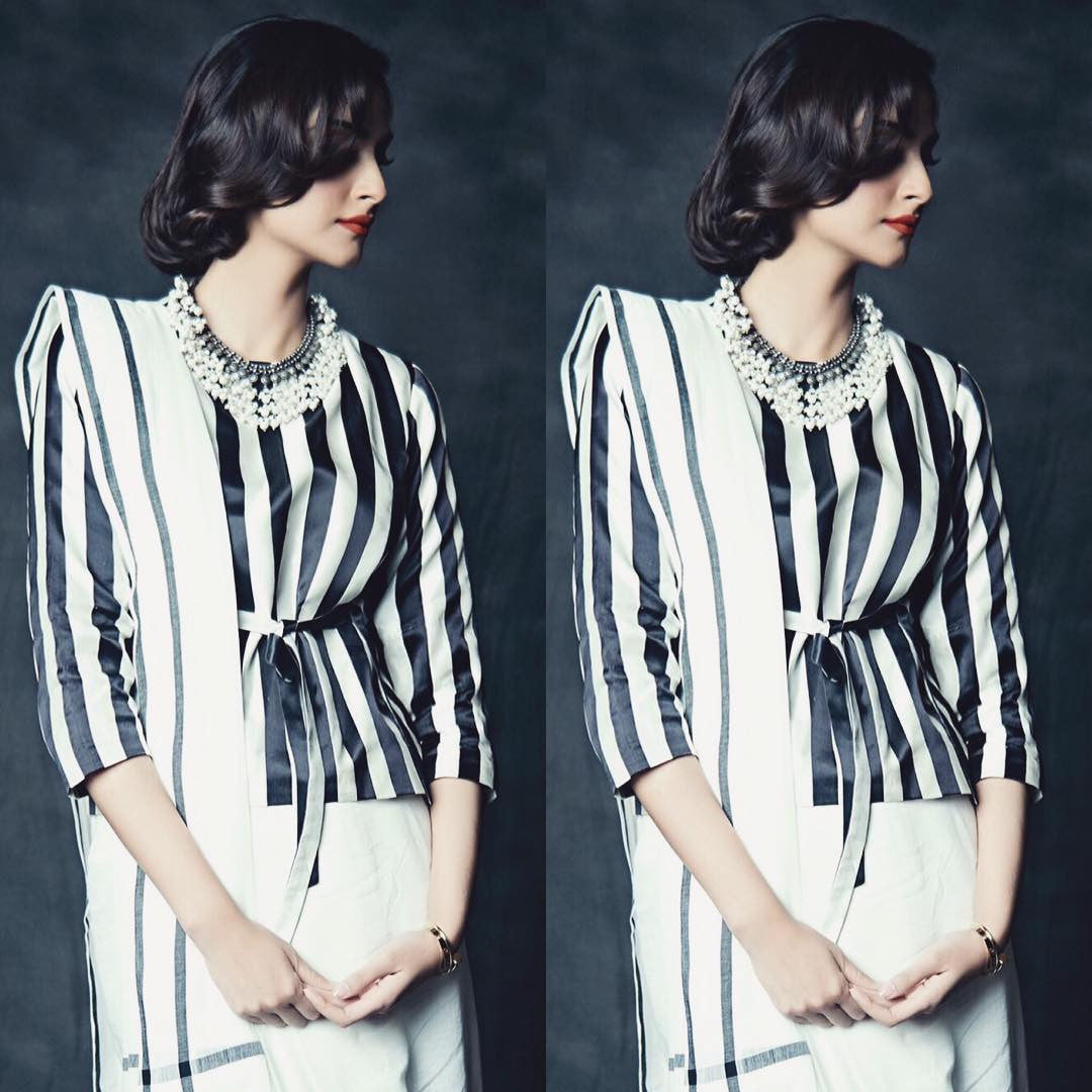 Sonam Kapoor attending the store launch at Mumbai Wearing a black and white striped long sleeved blouse from Raw Mango collection's saree in a Gujrati style drape