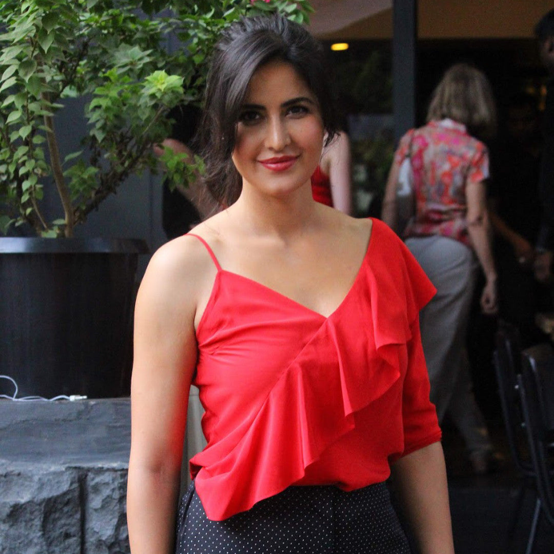 Katrina Kaif in Dvf collection's red one shoulder ruffle detail top, that she paired with polka dot wide legged pants