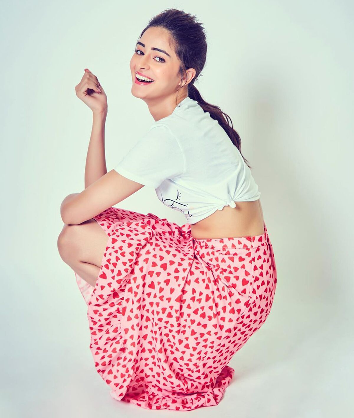 Ananya-Panday-in-pink-printed-skirt-teamup-with-white-crop-top