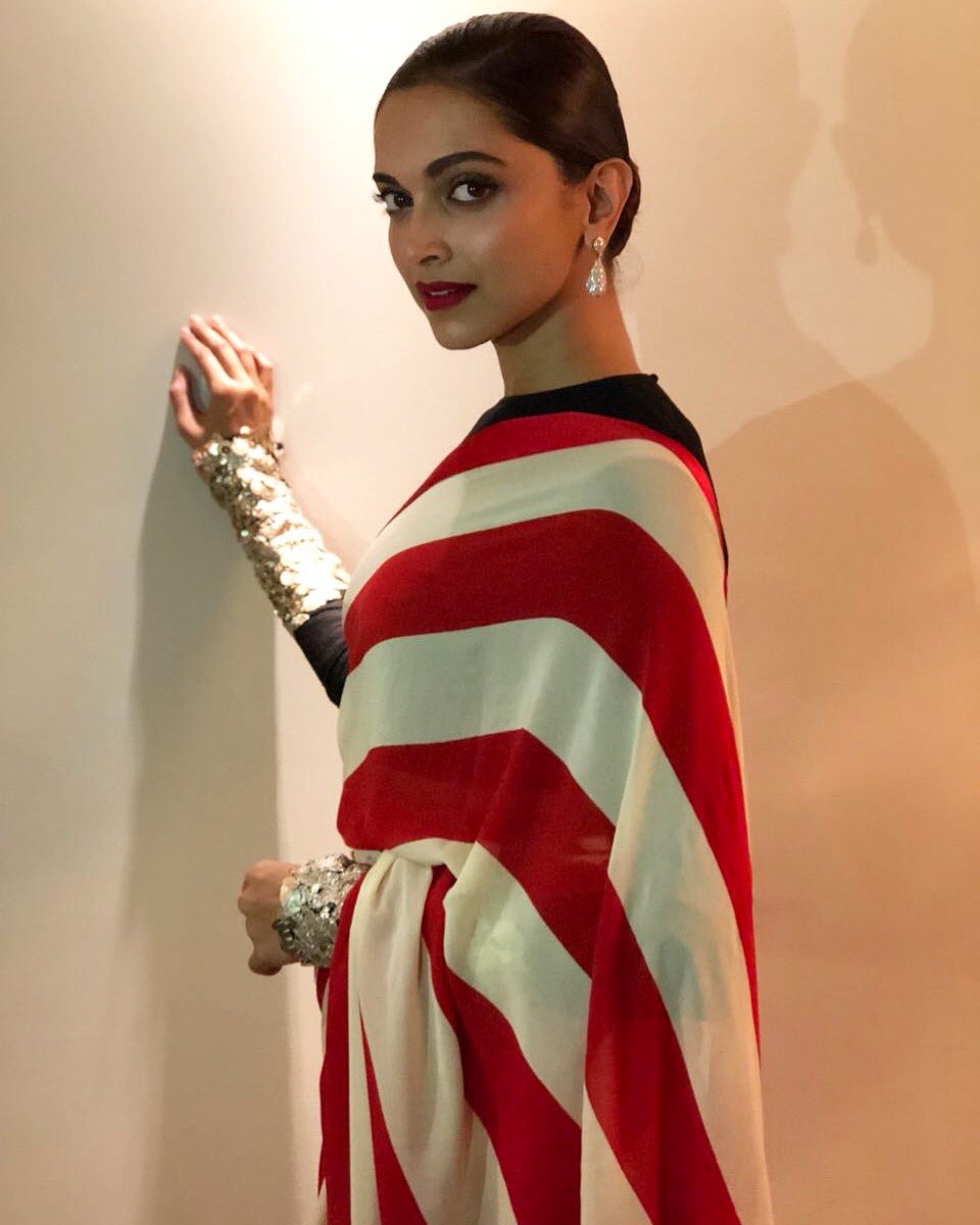 Deepika looked gorgeous in striped georgette saree with a textured full sleeve blouse and embroidered metallic cuffs from Sabyasachi's upcoming Spring Summer 2018 collection. 