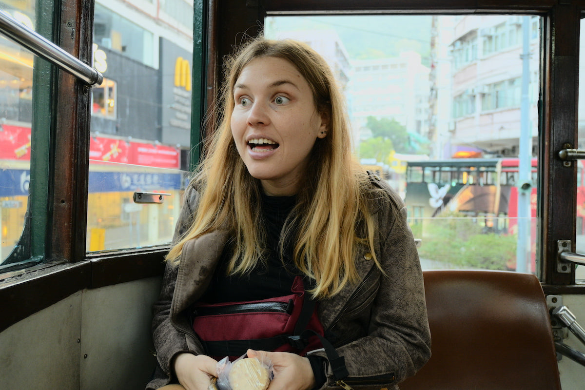 A tourist traveling by bus through the busy streets of hong kong