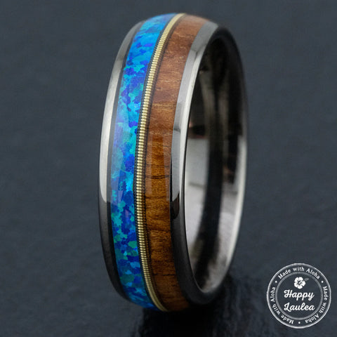 Gun-grey tungsten carbide ring with a guitar string, blue opal, & Hawaiian Koa wood inlay