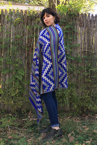 ShopMucho owner models Mexican clothing Southwest style shawl in blue aztec